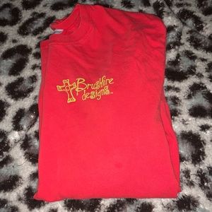 red cross t shirt with graphics. size large